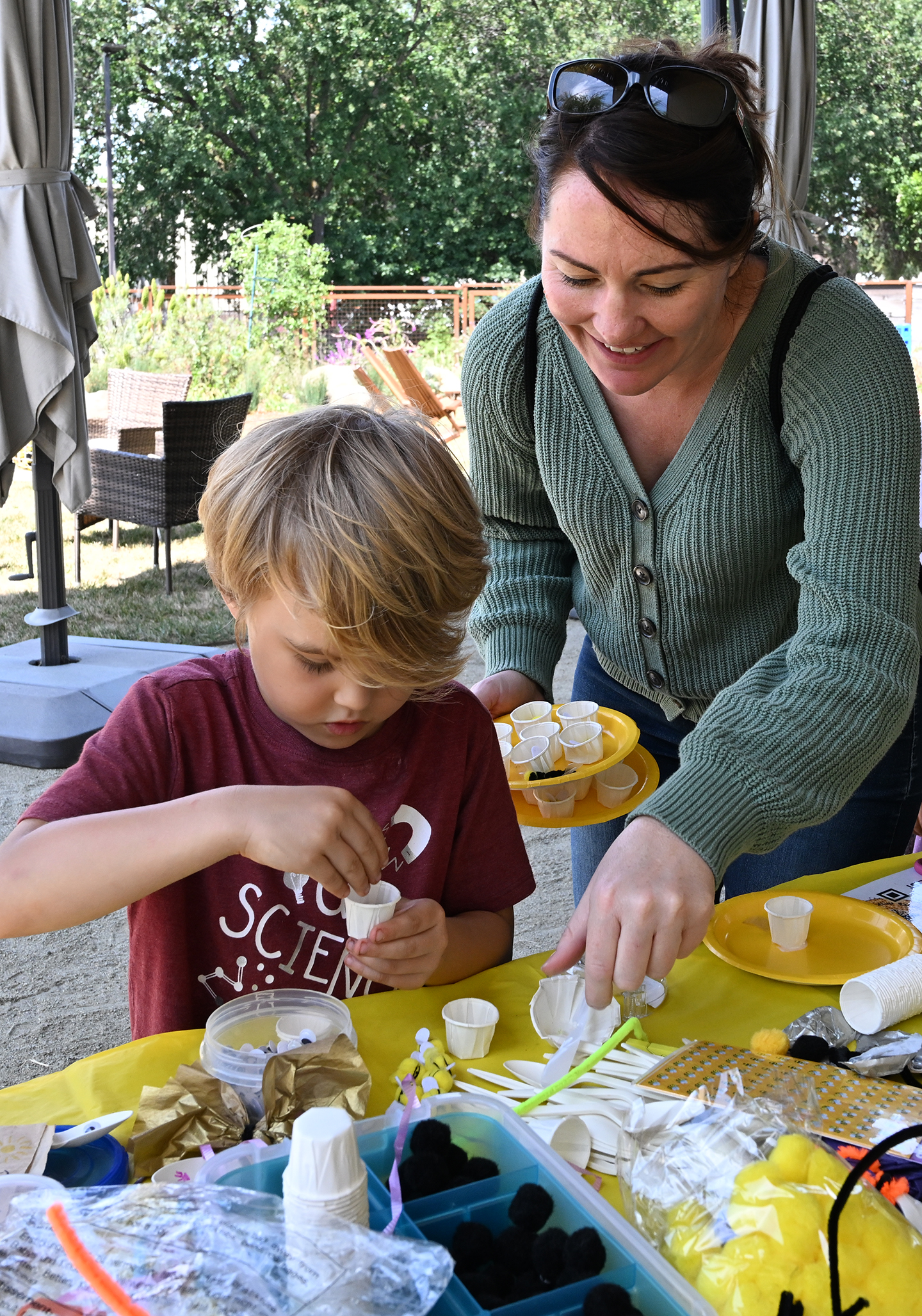 Leslie Roche, professor of Cooperative Extension, based in the UC Davis Department of Plant Sciences, watches as her son, Atticus, 6, works on projects. (Photo by Kathy Keatley Garvey)