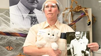 Tabatha Yang, Bohart Museum education and outreach coordinator, strikes a pose as Richard "Doc" Bohart, complete with a replica of his beloved cat, Beau. (Photo by Kathy Keatley Garvey)