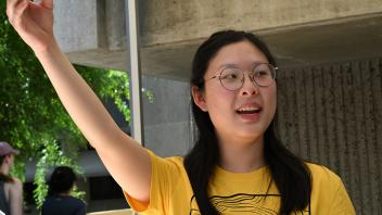 Alice Meng holds up one of the roach athletes. (Photo by Kathy Keatley Garvey)