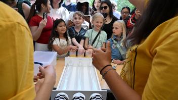 These youngsters are ready to pump air to encourage the roaches to leave the starting gate. (Photo by Kathy Keatley Garvey)