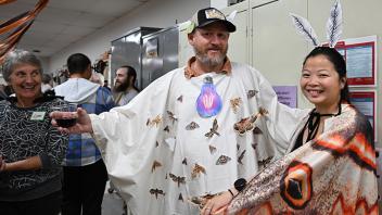 UC Davis distinguished professor emerita Lynn Kimsey admires the costumes of UC Davis alumna and entomologist Maia Lundy and Mike Walls (Photo by Kathy Keatley Garvey)