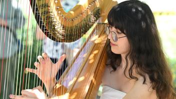 Harpist Samantha Murray, education and garden coordinator, performing in the garden