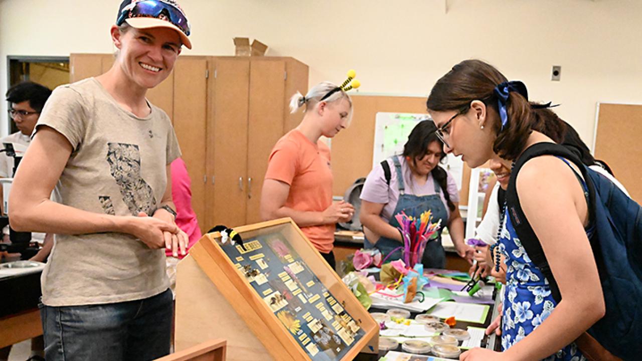 Rachel Vannette (foreground) and doctoral student (background) Gillian Bergmann greeting guests on UC Davis Picnic Day. The Vannette lab will be tabling at the Bohart Museum of Entomology open house on May 19. (Photo by Kathy Keatley Garvey)