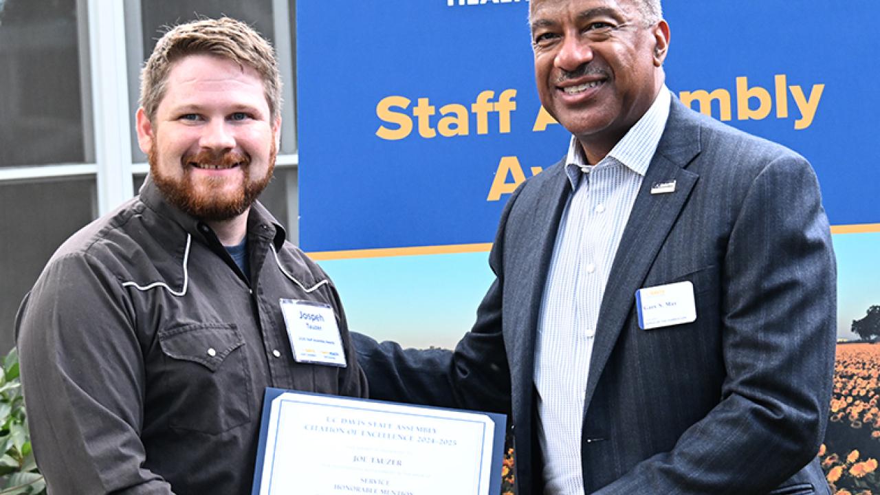 Joseph Tauzer, manager of the Harry H. Laidlaw Jr. Honey Bee Research Facility, receives congratulations from UC Davis Chancellor Gary May. (Photo by Kathy Keatley Garvey)