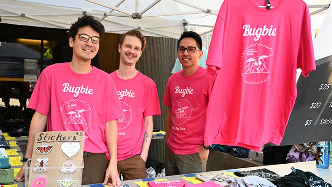 Three entomology students selling Bugbie T-shirts at Briggs Hall.