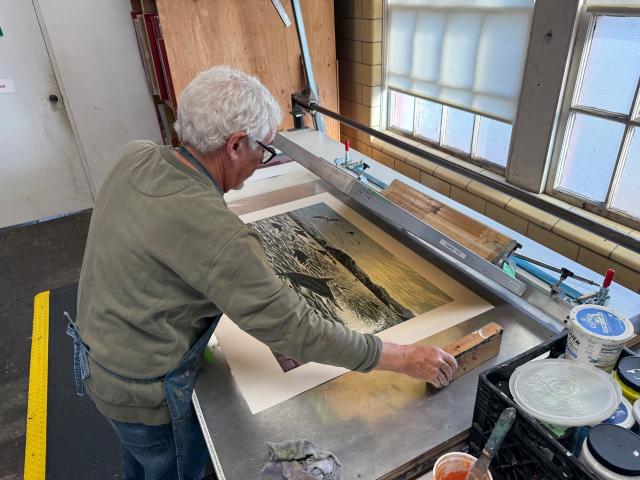 Printmaker Jos Sances working on a large print in his studio.