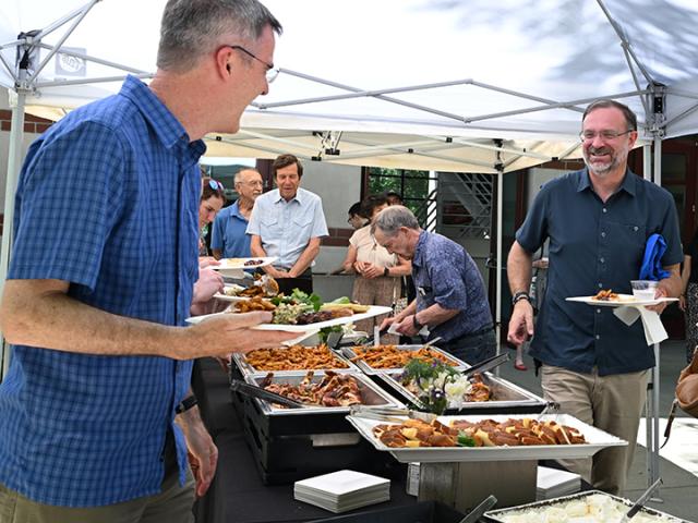 Professor Neal Williams shares a laugh with Professor Jason Bond at the retirement luncheon.