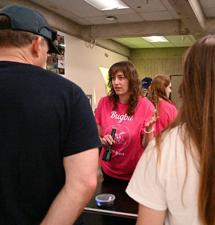 Marielle Simone Hansel Friedman of the Emily Meineke lab designed the Bugbie T-shirts. Here she talks to Briggs Hall visitors during the UC Davis Picnic Day celebration. (Photo by Kathy Keatley Garvey)