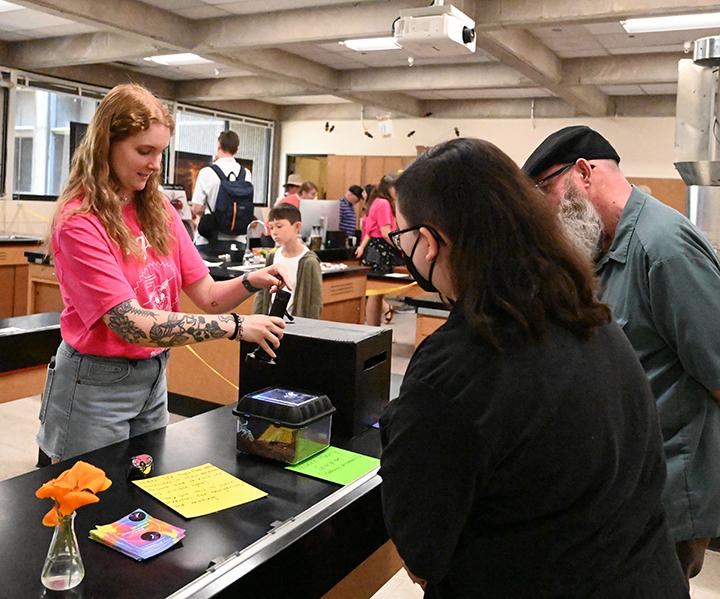 Emma "Em" Jochim demonstrated how scorpions fluoresce under UV light at the 2024 UC Davis Picnic Day. (Photo by Kathy Keatley Garvey)