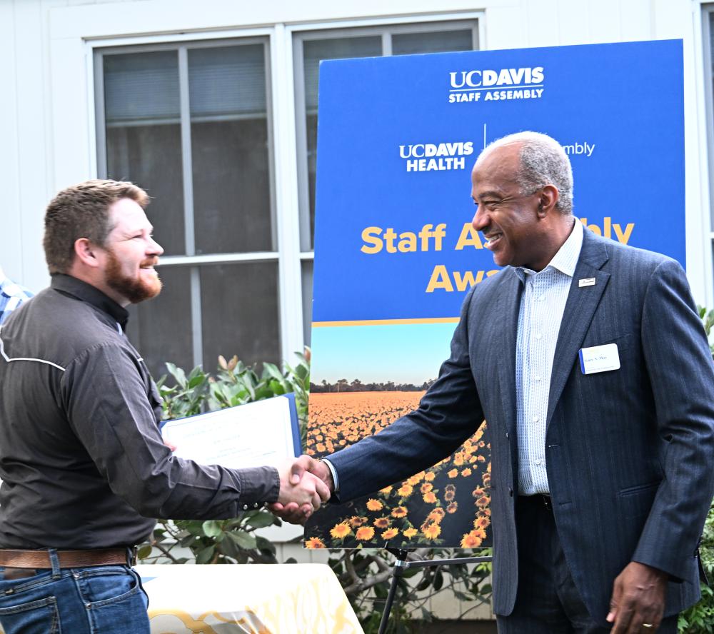 UC Davis Chancellor Gary May shakes the hand of Joseph Tauzer, recipient of a campuswide service award from UC Davis Staff Assembly. (Photo by Kathy Keatley Garvey)