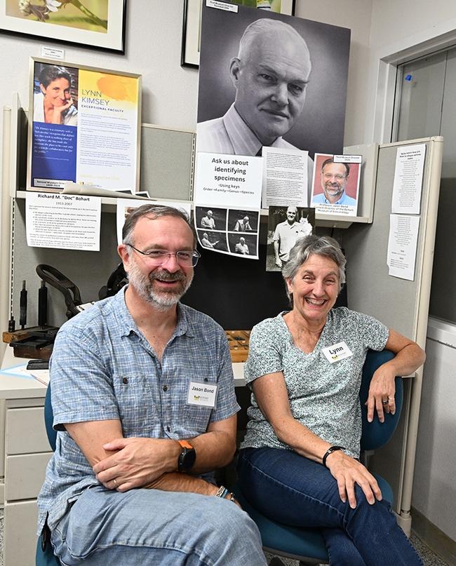 Bohart Museum director Jason Bond and former director Lynn Kimsey in front of a portrait of the founder, Richard "Doc" Bohart. (Photo by Kathy Keatley Garvey)