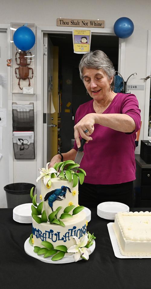 UC Davis distinguished professor emerita Lynn Kimsey cutting a Hymenoptera-themed cake