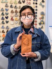 Heidi Tejeda Mata with bisque fired tile