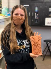 Kimberly Moniz with bisque fired tile