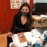 Adeliz Ulloa with glazed bisque fired tile her own colors