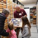Jeff Smith, curator of the Lepidoptera collection at the Bohart Museum, shows visitors some of the collection. (Photo by Kathy Keatley Garvey)