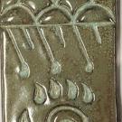 This design shows a central bear’s paw with the claws in the shape of raindrops with symbolic clouds and rain above it.