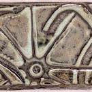 This tile shows an intertwining snake design on a geometric background.