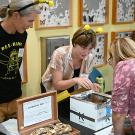 Associate professor Rachel Vannette (left) and junior specialist Leta Landucci of the Vannette lab talk to attendees at the Bohart Museum of Entomology open house. (Photo by Kathy Keatley Garvey)