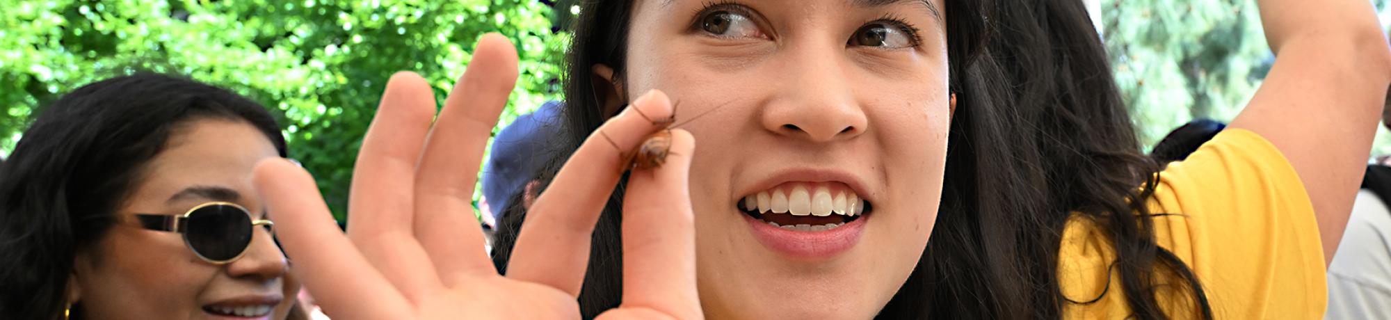 Doctoral student Veronica Casey holds a cockroach. (Photo by Kathy Keatley Garvey)